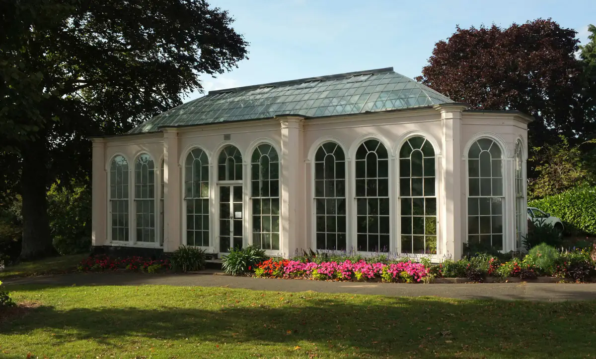Georgian orangery with tall arched windows and a glazed roof at Bitton House, Teignmouth